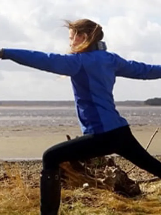 Saffron doing yoga on the beach.