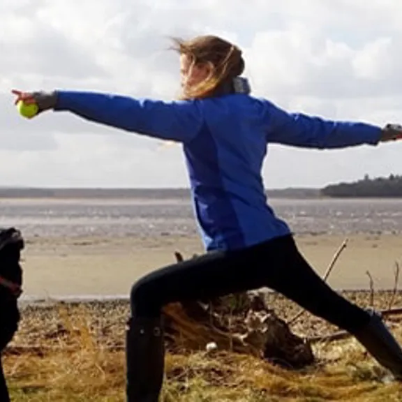 Saffron doing yoga on the beach.