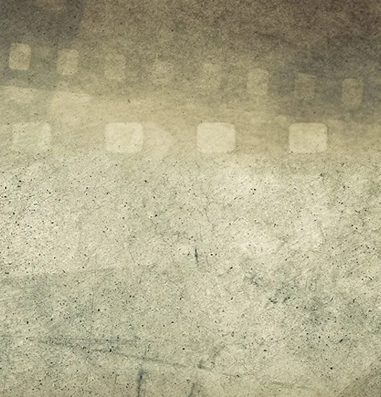 A vintage-style background with a weathered, grainy texture. The faint, transparent outline of a filmstrip with perforations is visible across the top and down the sides of the image. The image evokes themes of filmmaking, photography, and history.