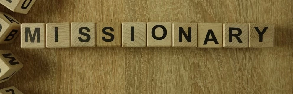 The word 'missionary' spelled out on wooden letters. 