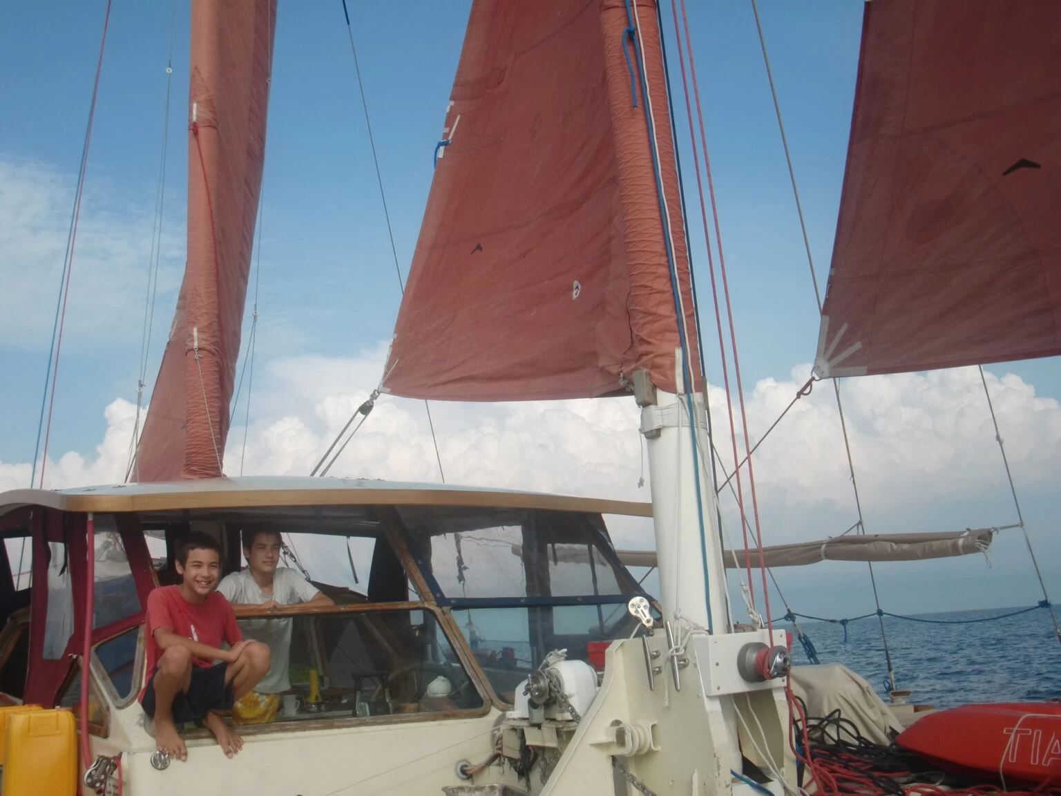 The Springett children looking at the camera on a boat. 