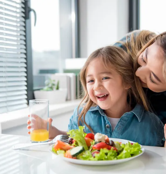 Child eating a healthy salad.