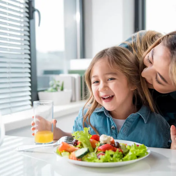 Child eating a healthy salad.