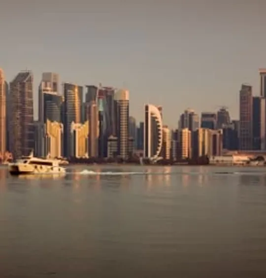 A landscape view of a Qatari city skyline, at sunset.