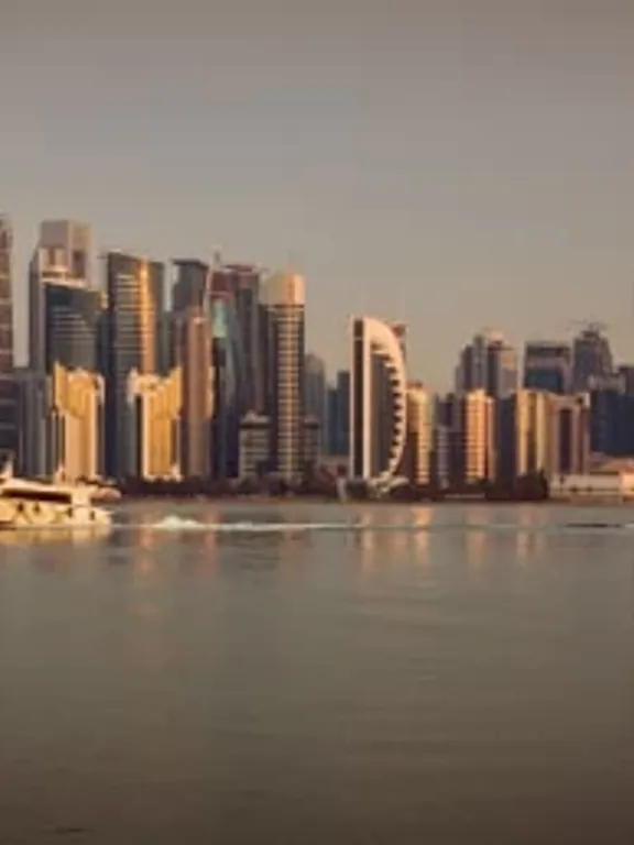 A landscape view of a Qatari city skyline, at sunset.
