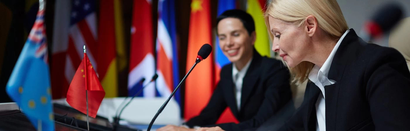Two country leaders discussing with each other at a world political conference. 