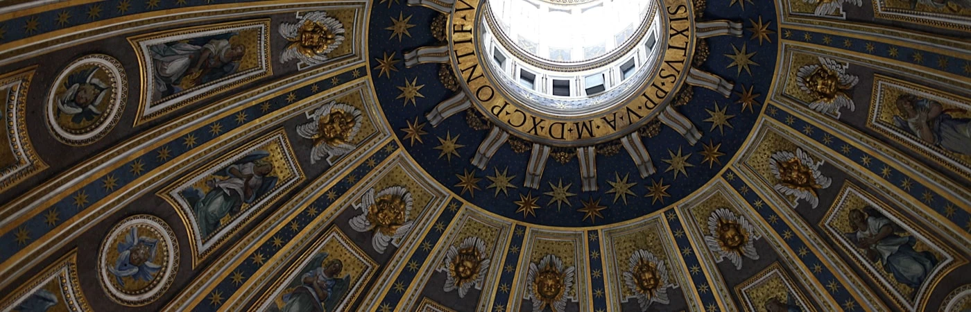 Inside of a renaissance style building, looking at a grand ceiling