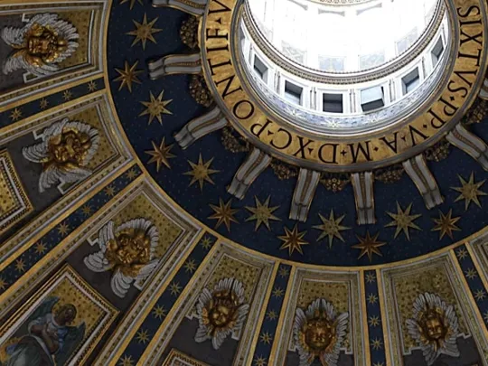 Inside of a renaissance style building, looking at a grand ceiling