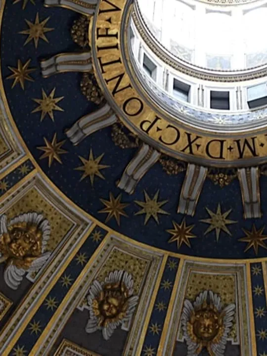 Inside of a renaissance style building, looking at a grand ceiling