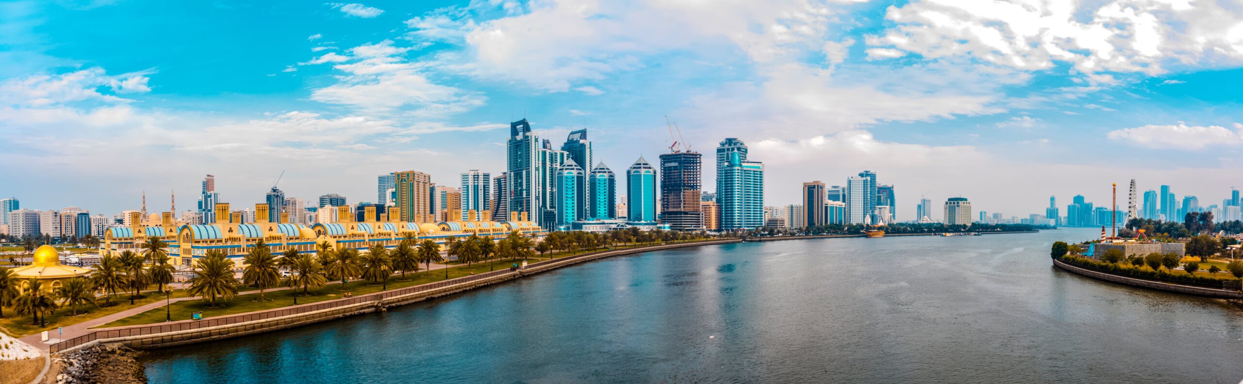 Panoramic view of the modern Sharjah skyline and waterfront, highlighting the vibrant environment for homeschooling families in the UAE.