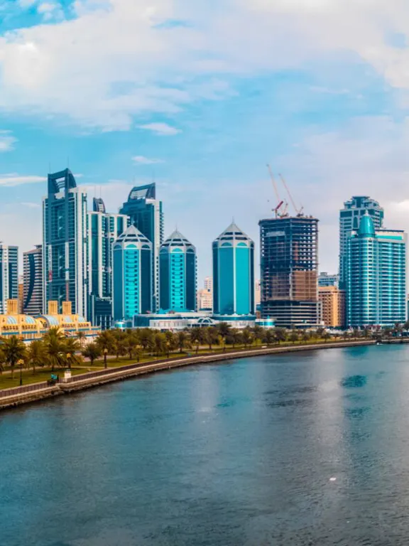 Panoramic view of the modern Sharjah skyline and waterfront, highlighting the vibrant environment for homeschooling families in the UAE.