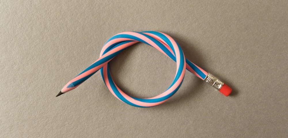 A flexible, striped pencil bent into a loop, symbolising adaptability.