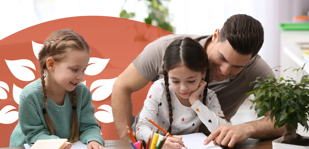 A dad homeschooling his two young daughters at a desk.
