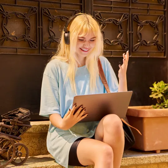 A blurry, long-exposure photo of business people in motion walking down a modern, white, brightly-lit corporate walkway, symbolizing the fast pace of business management.