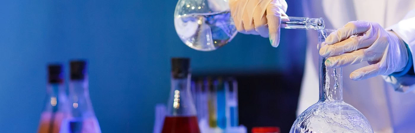 Scientist using science equipment in a chemistry experiment. 