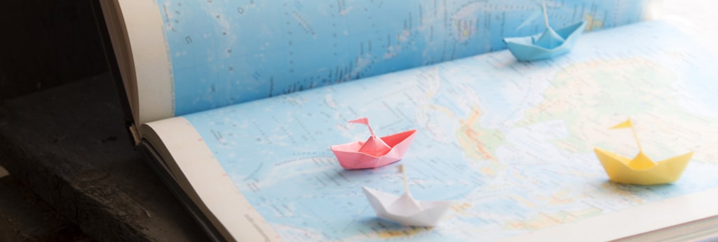 Paper boats on a map. 