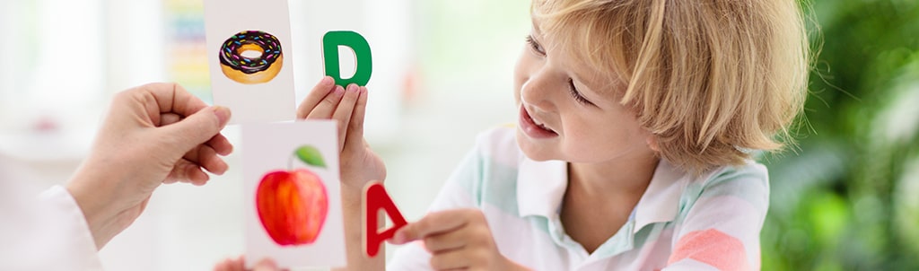Smiling student with notebook and pen, studying in a cosy home setting with sunlight through window