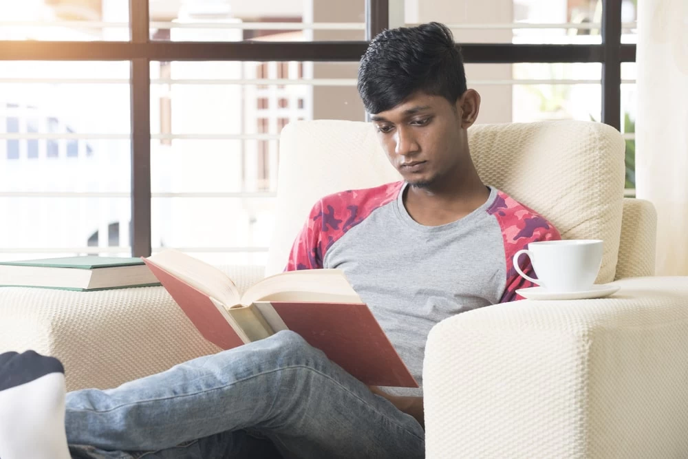 English student reading one of his books. 