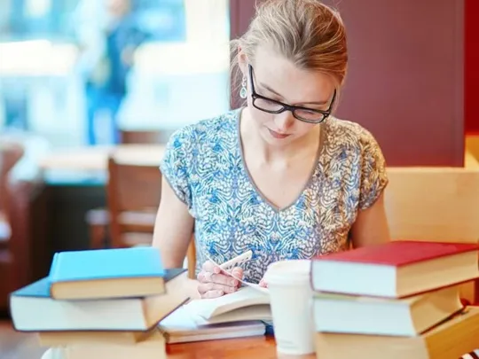 A woman reading in a parisian cafe.