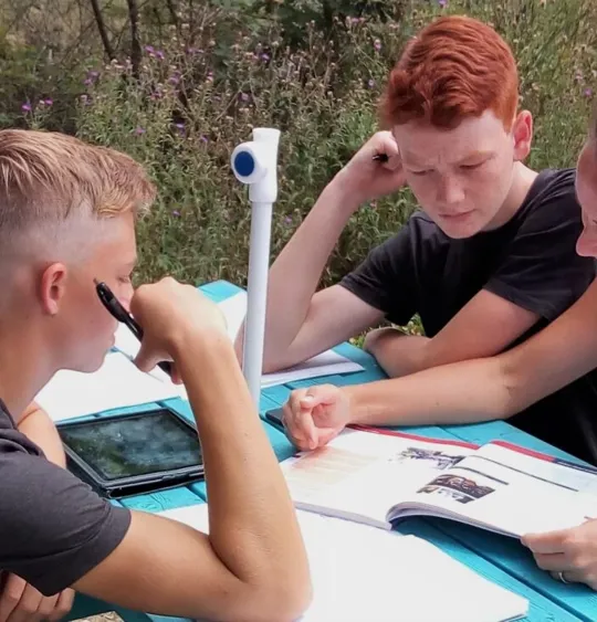 Karren helping Aiden, and Sebastian.