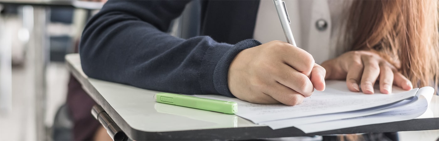 Homeschooling college student taking an exam at an exam centre.
