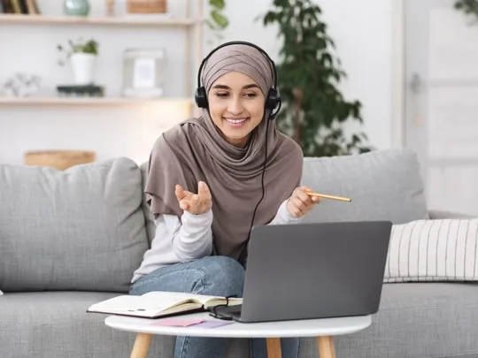 GCSE Level student using her laptop for a video call.